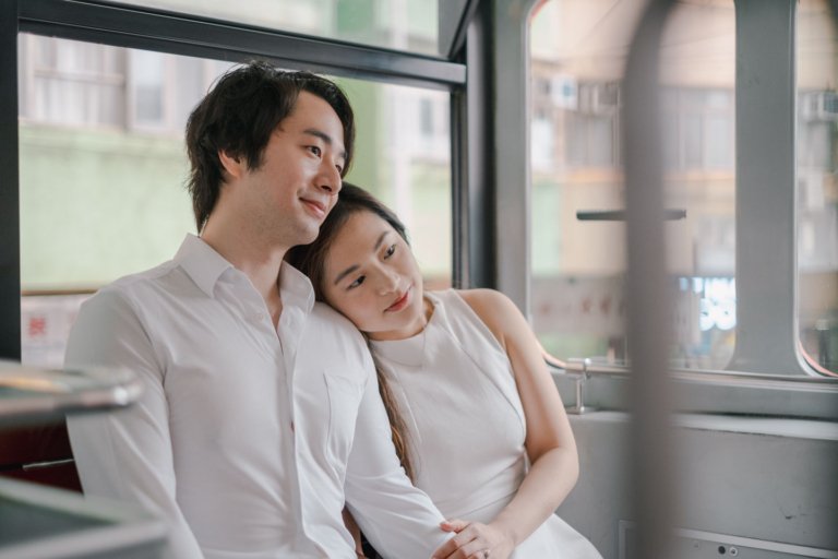 Romantic prewedding portrait of a young couple in a scenic outdoor setting at their alma mater in Hong Kong, surrounded by lush greenery and natural beauty, part of a seaside series (11/14).